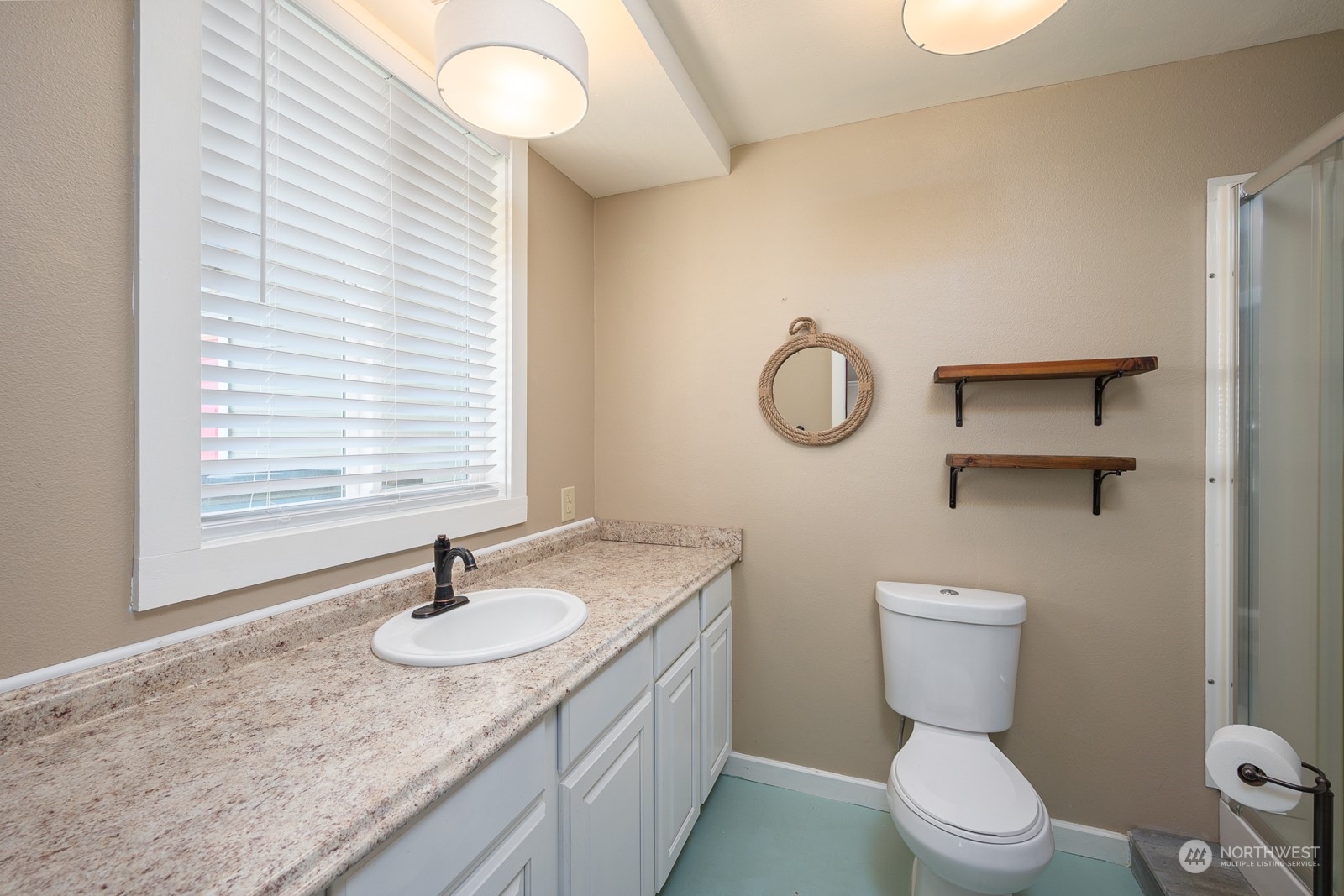 464 Patrick Road Ephrata, WA 98823 - Photo 20 of 30 a bathroom with a granite countertop sink toilet and a mirror