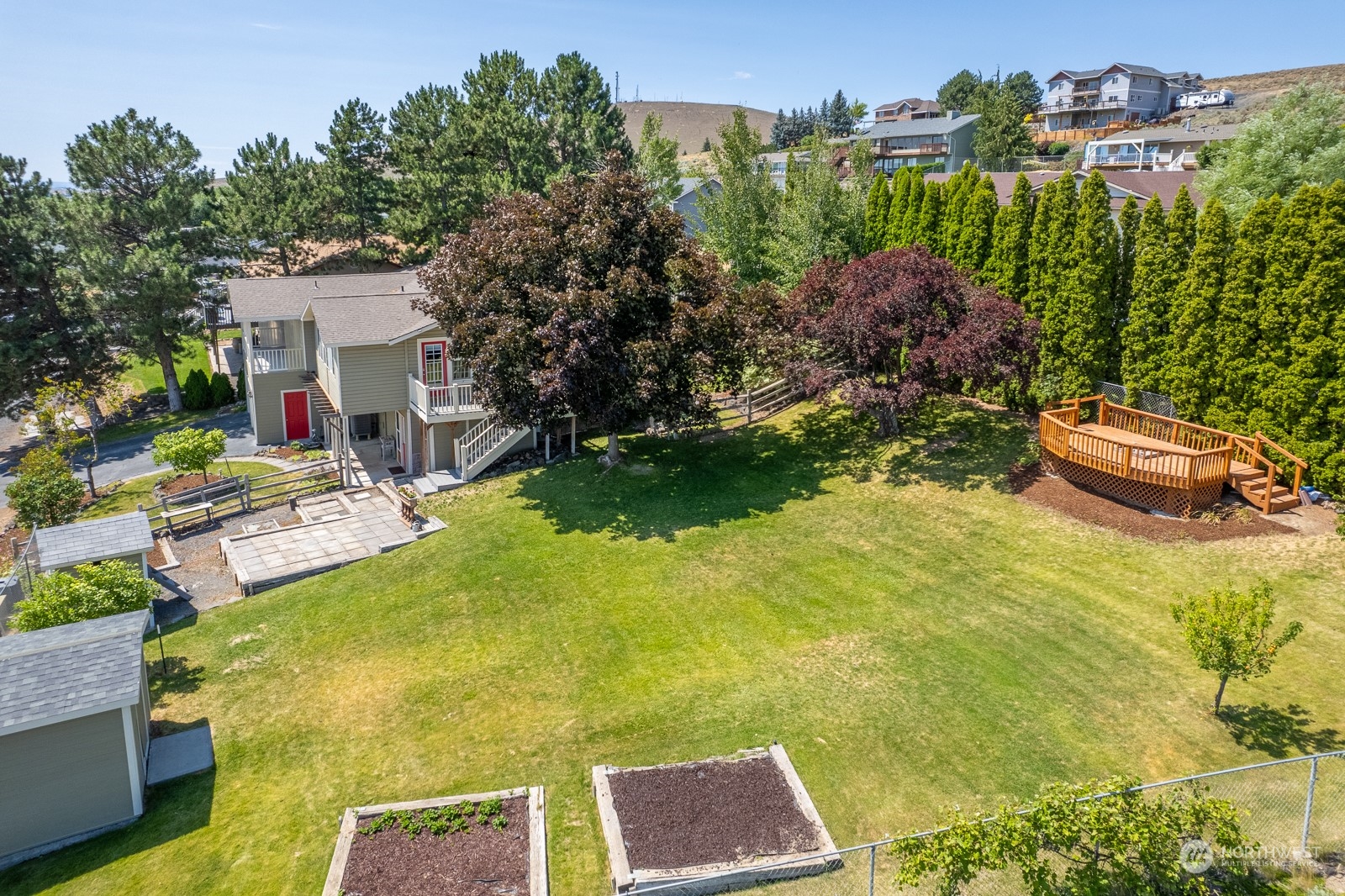 464 Patrick Road Ephrata, WA 98823 - Photo 25 of 30 a view of a swimming pool with some plants and a bench