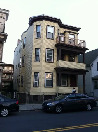 a front view of a house with parking space