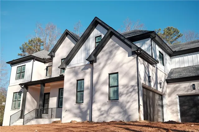 a front view of a house with a street