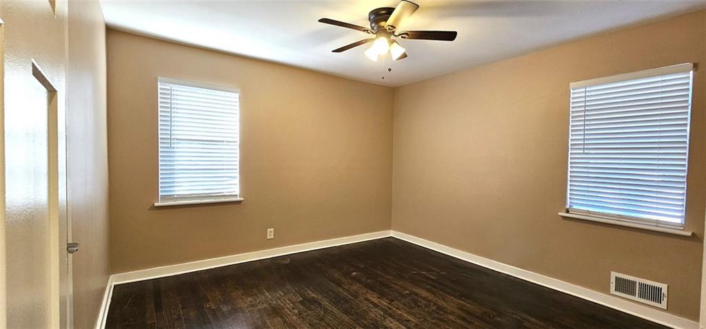 1291 Lorenzo Drive Southwest Atlanta, GA 30310 - Photo 12 of 17 a view of a room with wooden floor and windows