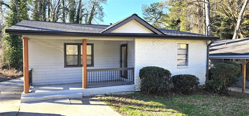 1291 Lorenzo Drive Southwest Atlanta, GA 30310 - Photo 16 of 17 a front view of a house with garden