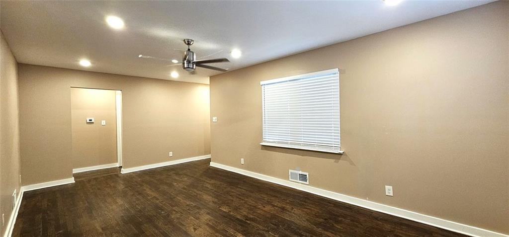 1291 Lorenzo Drive Southwest Atlanta, GA 30310 - Photo 2 of 17 an empty room with wooden floor and windows