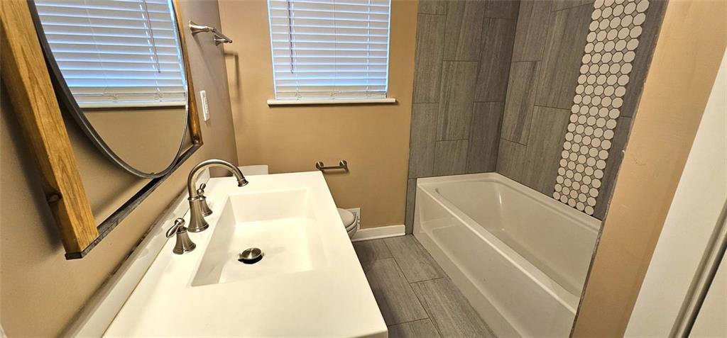1291 Lorenzo Drive Southwest Atlanta, GA 30310 - Photo 10 of 17 a bathroom with a bathtub and a shower