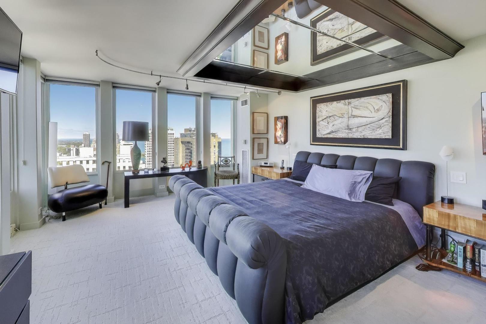 100 East Walton Street, Unit 42F Chicago, IL 60611 - Photo 29 of 52 a bed room with a bed and a large mirror