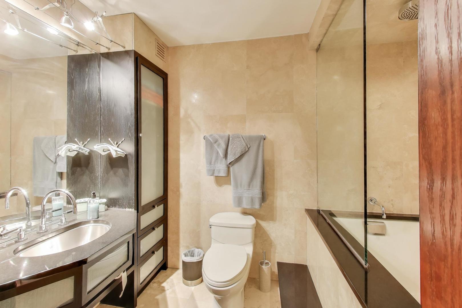 100 East Walton Street, Unit 42F Chicago, IL 60611 - Photo 40 of 52 a bathroom with a granite countertop sink toilet and shower