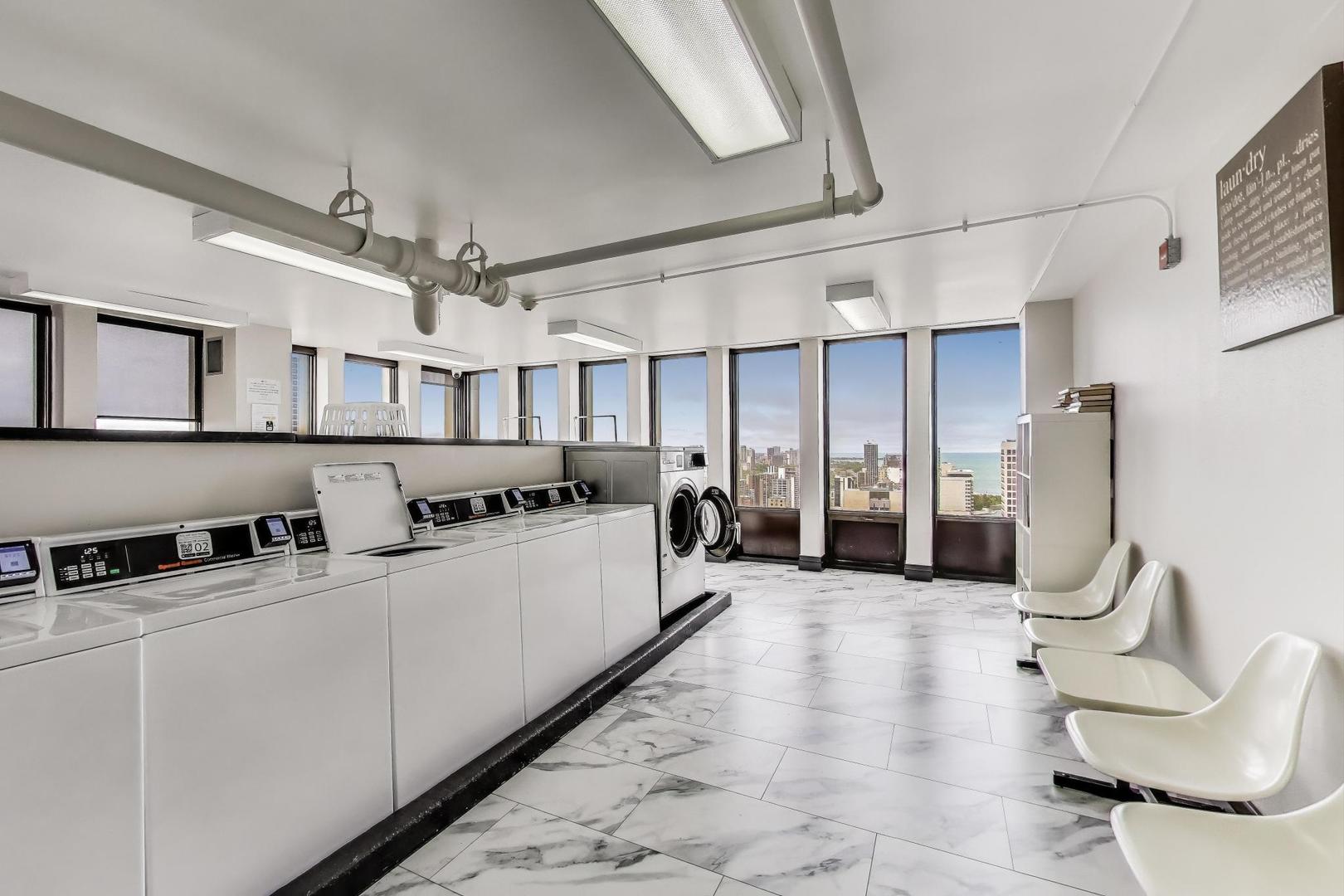100 East Walton Street, Unit 42F Chicago, IL 60611 - Photo 47 of 52 a kitchen with stainless steel appliances kitchen island granite countertop a refrigerator a sink dishwasher and white cabinets next to a window