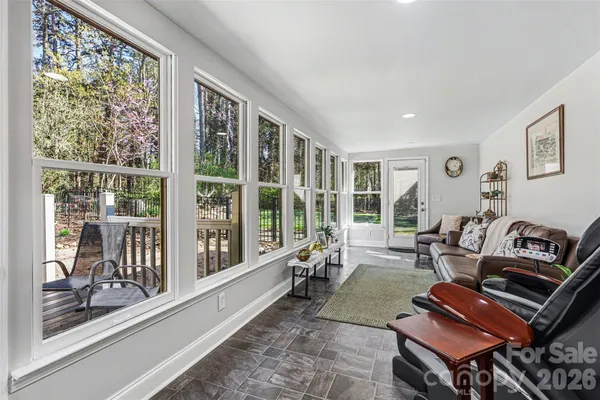a living room with furniture and a floor to ceiling window