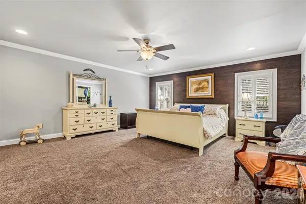 a spacious bedroom with a bed and a couch