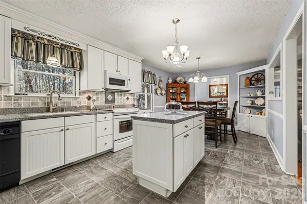 a kitchen with a stove cabinets and window