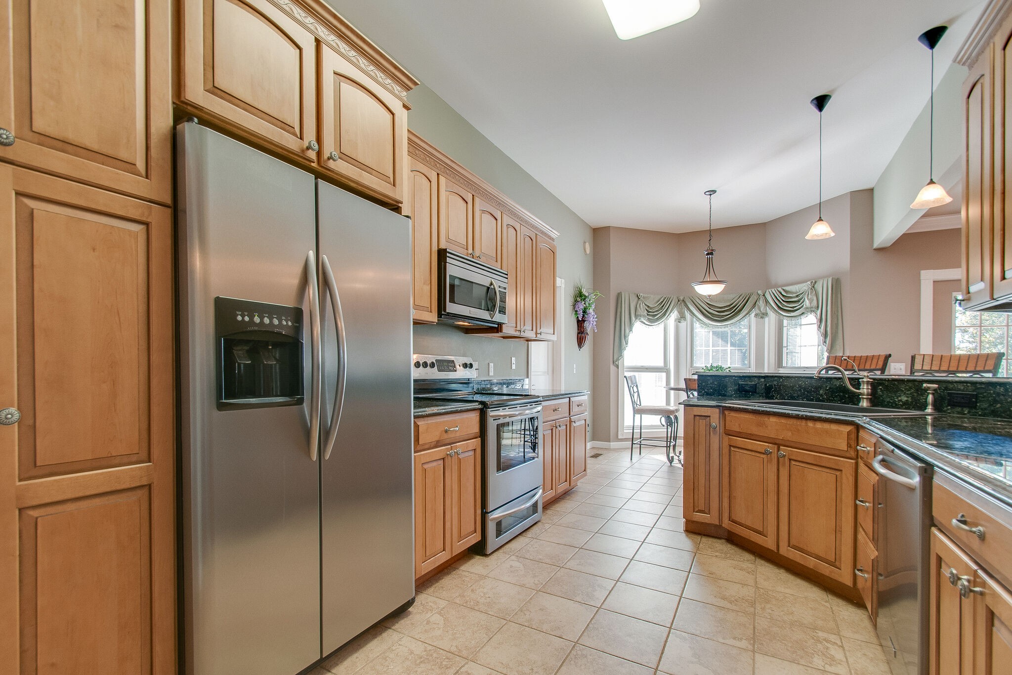 1230 Grindstone Hollow Road Dickson, TN 37055 - Photo 18 of 50 a large kitchen with stainless steel appliances granite countertop a refrigerator and a sink