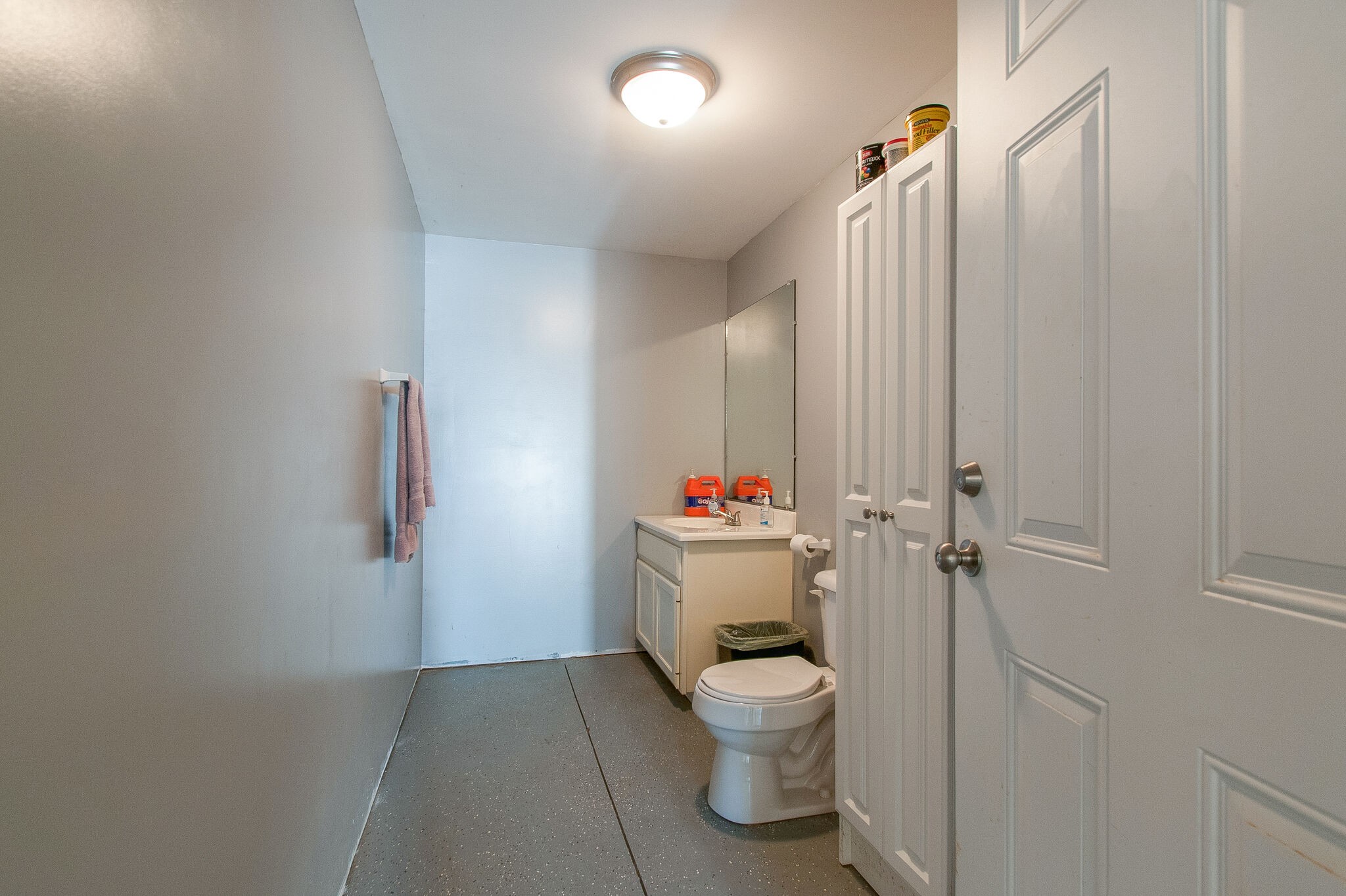 1230 Grindstone Hollow Road Dickson, TN 37055 - Photo 46 of 50 a white toilet sitting next to a bathroom sink and vanity
