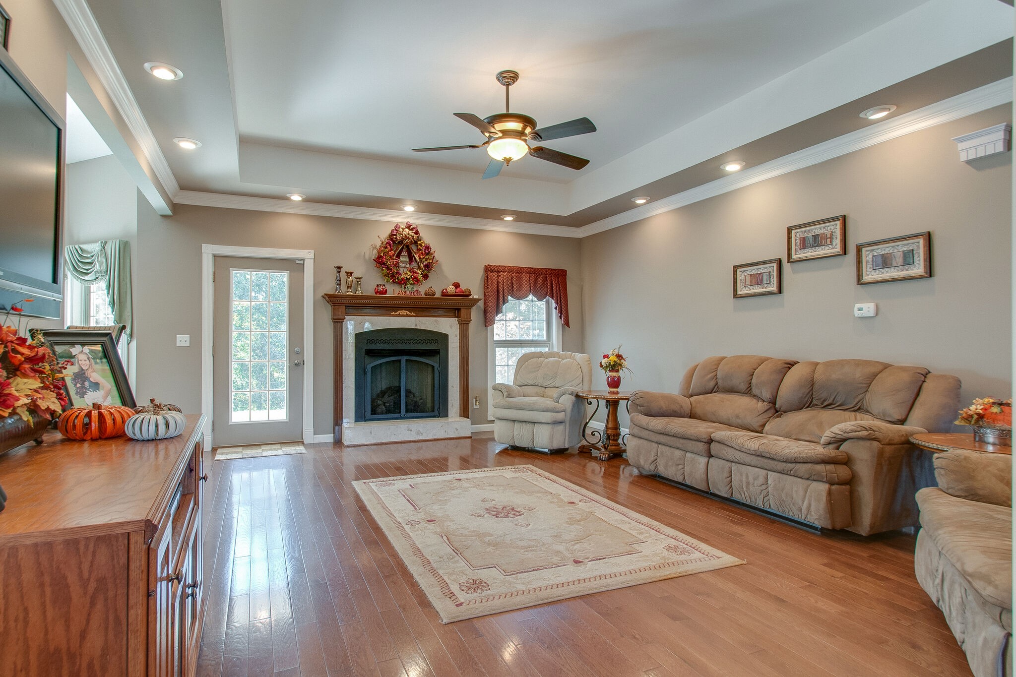 1230 Grindstone Hollow Road Dickson, TN 37055 - Photo 9 of 50 a living room with furniture a fireplace and a chandelier