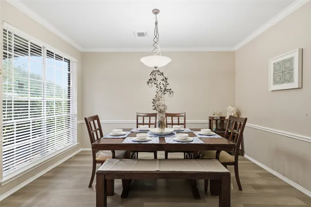 a dining room with furniture and window