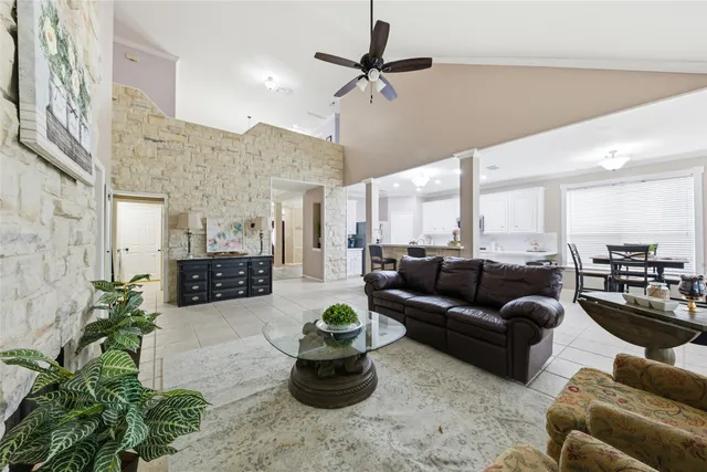 a living room with furniture a rug and a chandelier
