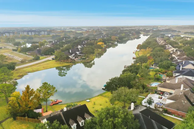 an aerial view of residential houses with outdoor space