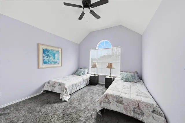 a bedroom with 2 bed and a window