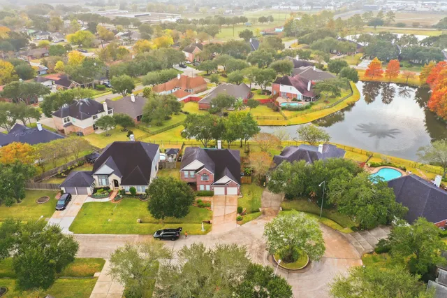an aerial view of residential houses with outdoor space and street view