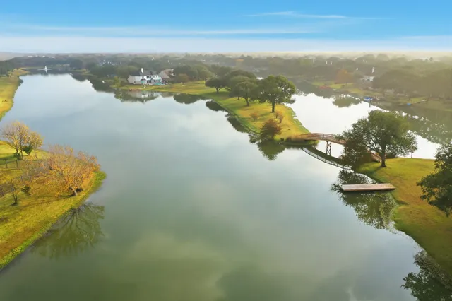 an aerial view of residential houses with outdoor space and swimming pool