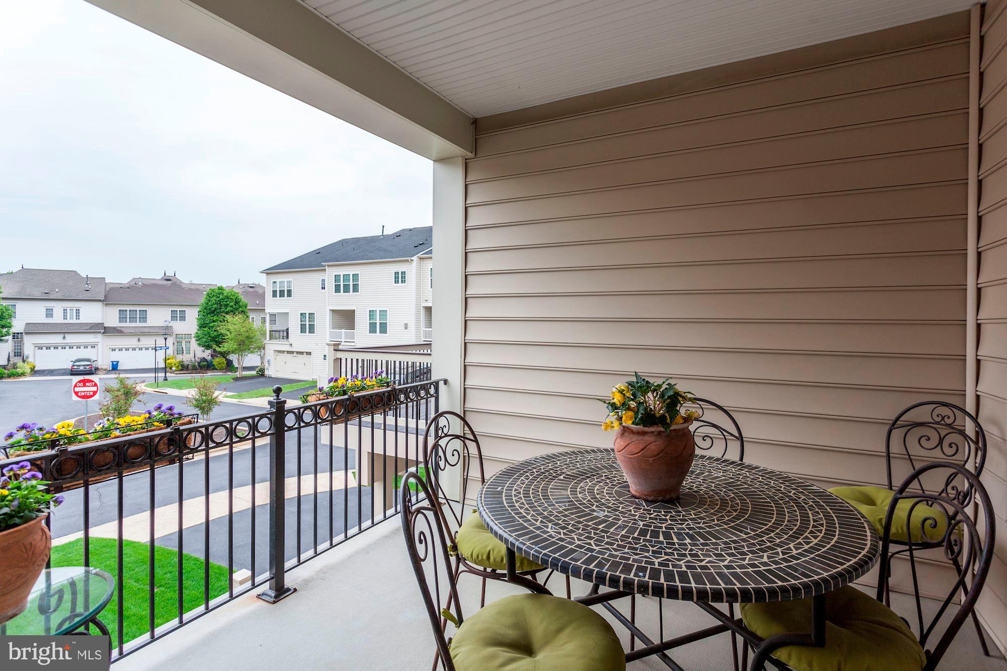 24960 Castleton Drive Chantilly, VA 20152 - Photo 39 of 44 a view of a roof deck with table and chairs