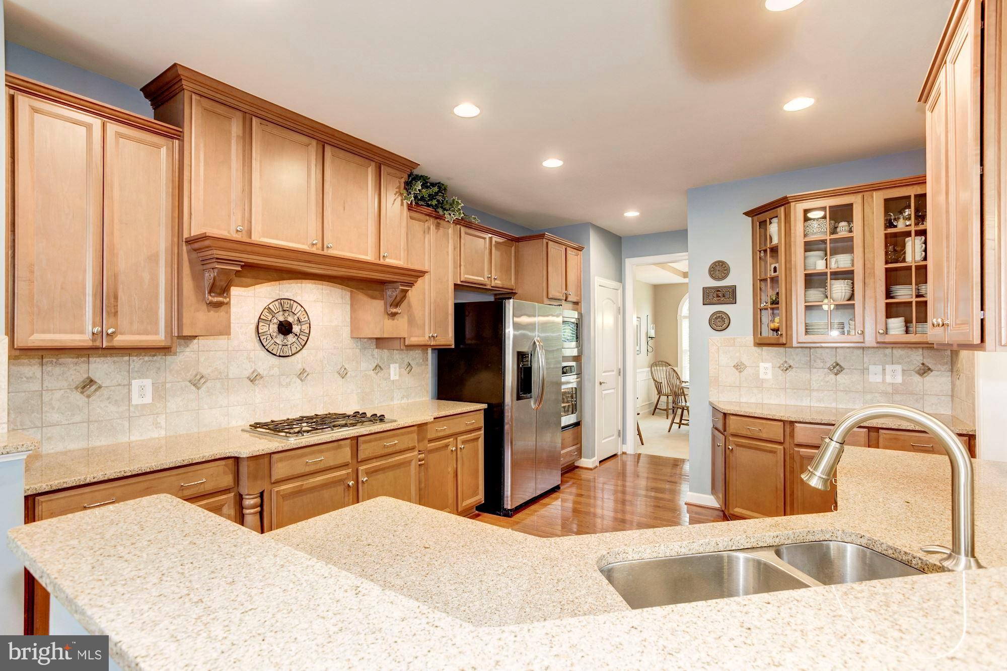 24960 Castleton Drive Chantilly, VA 20152 - Photo 8 of 44 a kitchen with stainless steel appliances granite countertop a sink and a refrigerator