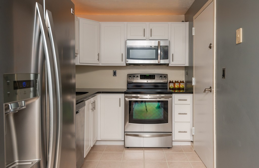189 Littleton Road, Unit 19 Chelmsford, MA 01824 - Photo 11 of 42 a kitchen with stainless steel appliances a refrigerator a stove and a sink