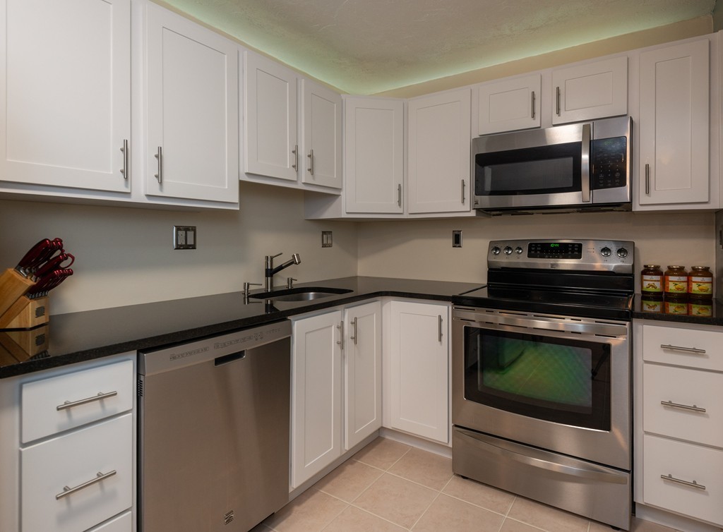 189 Littleton Road, Unit 19 Chelmsford, MA 01824 - Photo 12 of 42 a kitchen with white cabinets and stainless steel appliances