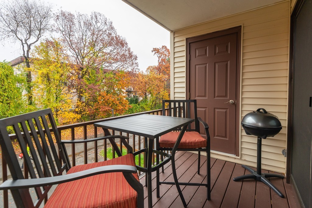 189 Littleton Road, Unit 19 Chelmsford, MA 01824 - Photo 16 of 42 a balcony with table and chairs