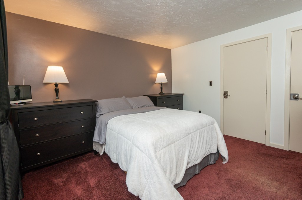 189 Littleton Road, Unit 19 Chelmsford, MA 01824 - Photo 32 of 42 a bedroom with a bed and a lamp
