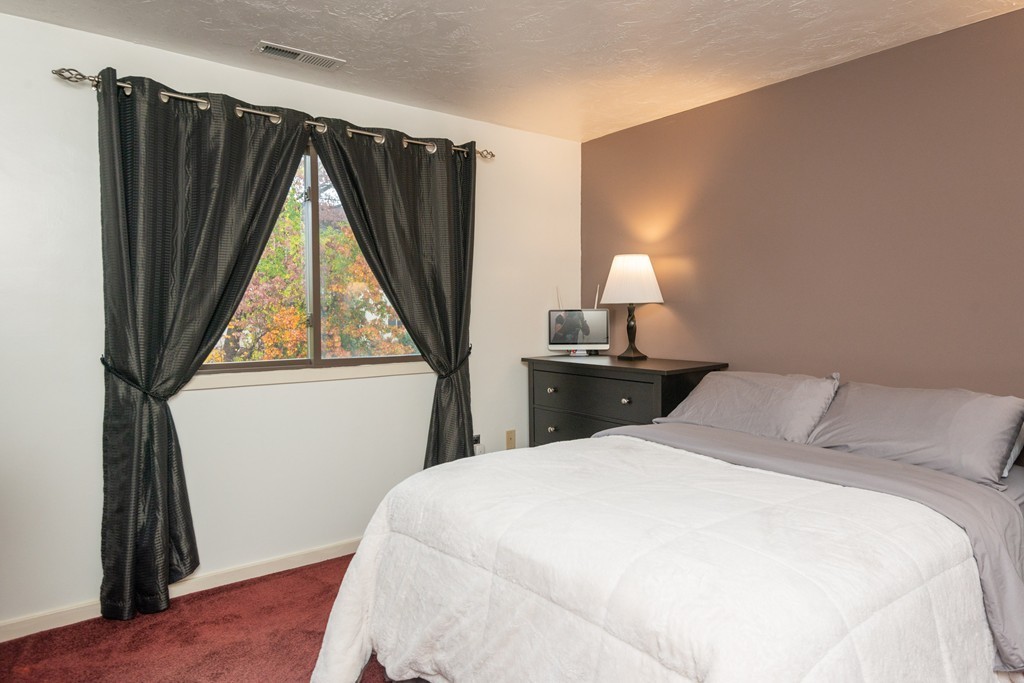 189 Littleton Road, Unit 19 Chelmsford, MA 01824 - Photo 34 of 42 a bedroom with a bed and a window
