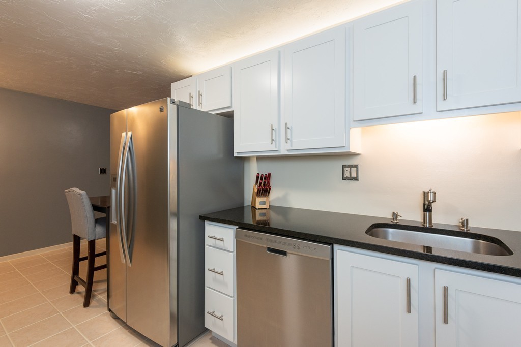 189 Littleton Road, Unit 19 Chelmsford, MA 01824 - Photo 4 of 42 a kitchen with stainless steel appliances granite countertop a refrigerator and a sink