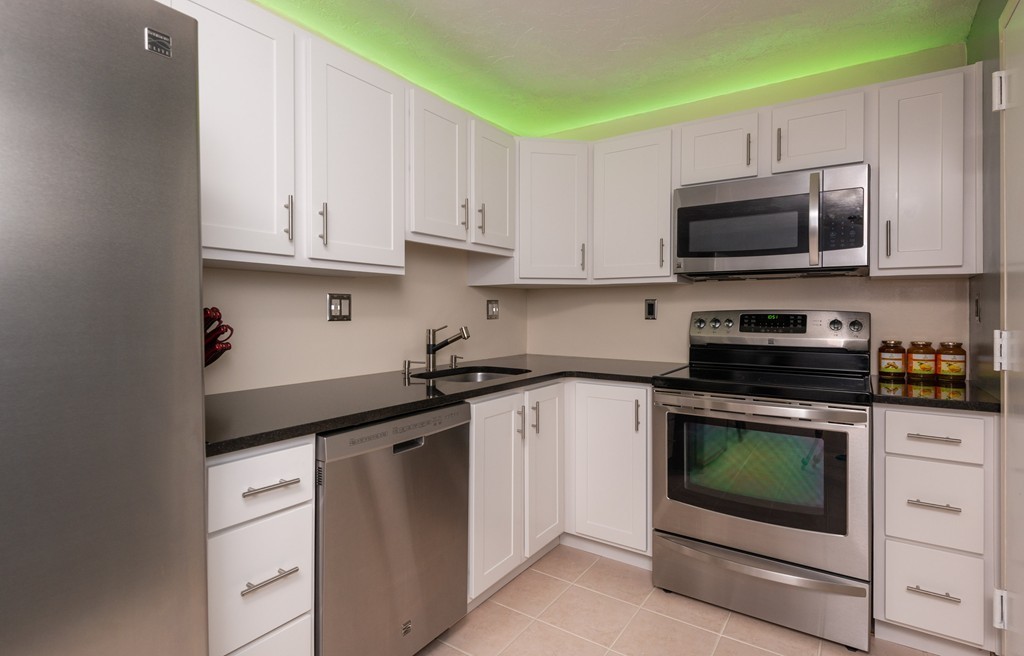 189 Littleton Road, Unit 19 Chelmsford, MA 01824 - Photo 7 of 42 a kitchen with cabinets stainless steel appliances and a sink