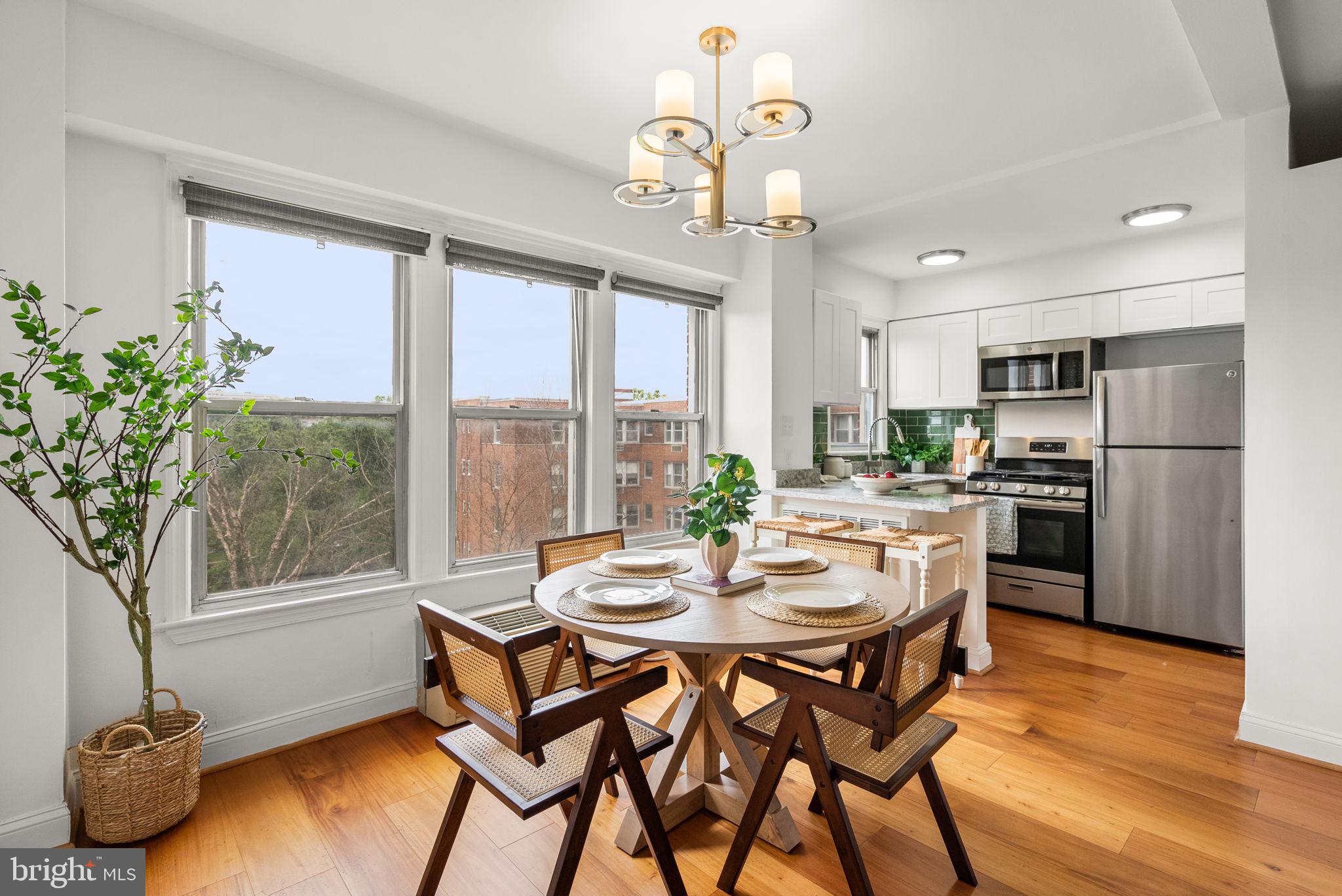 2500 Q Street Northwest, Unit 524 Washington, DC 20007 - Photo 1 of 50 a dining room with furniture a chandelier and wooden floor