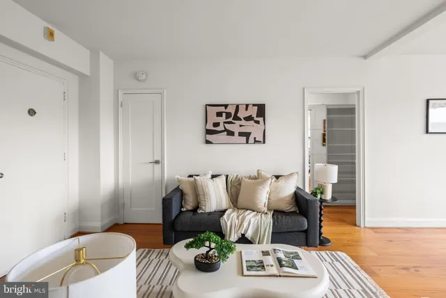 a living room with furniture and wooden floor