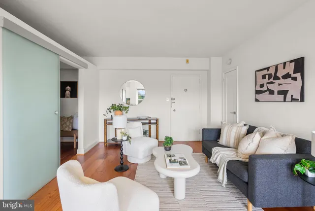 a living room with furniture and wooden floor