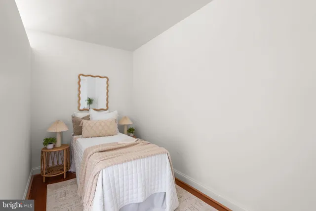 a bedroom with a bed and a table