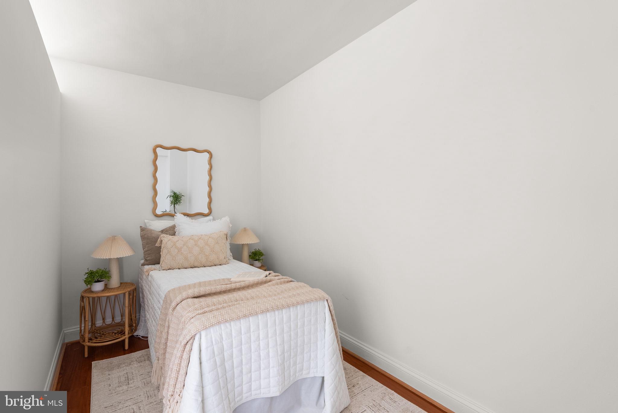 2500 Q Street Northwest, Unit 524 Washington, DC 20007 - Photo 19 of 50 a bedroom with a bed and a table