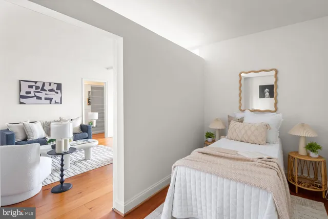 a bedroom with a bed and a couch