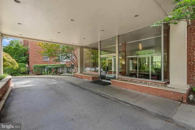 a view of a room with a large window and wooden fence
