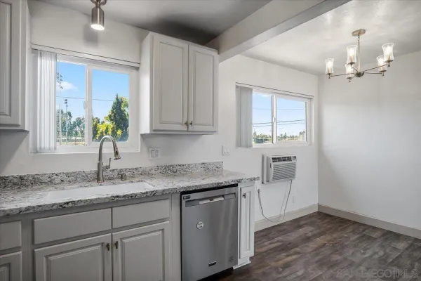 a kitchen with a sink cabinets and wooden floor