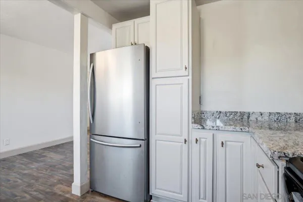 a white refrigerator freezer and a stove sitting inside of a kitchen