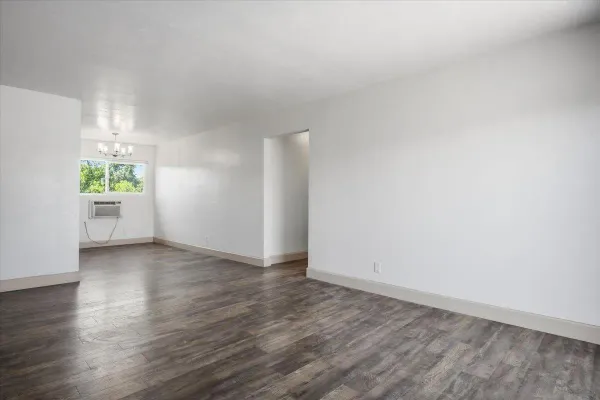 wooden floor in an empty room with a window