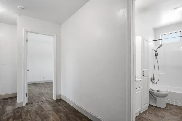 a bathroom with a granite countertop toilet and a sink