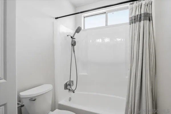 a bathroom with a shower a toilet and a shower