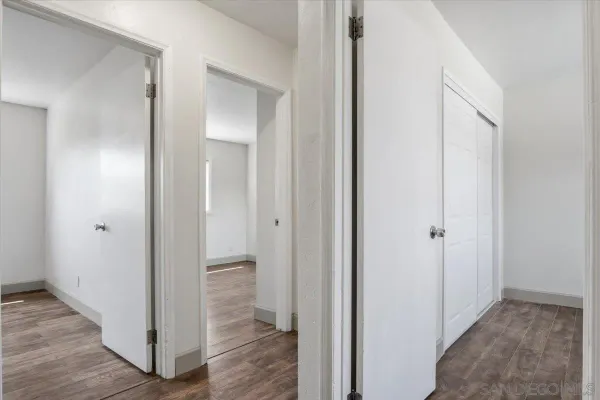 a view of a hallway with wooden floor