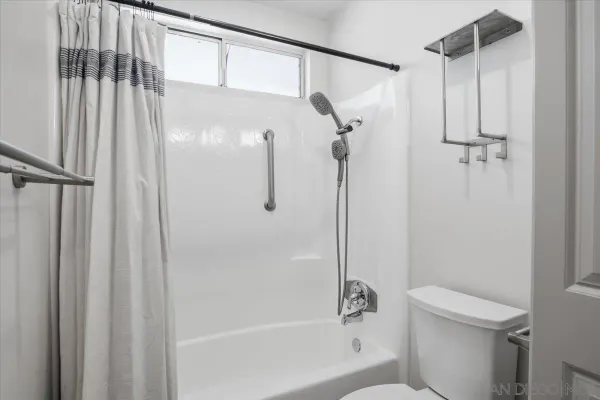 a bathroom with a shower and a toilet