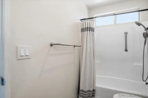 a bathroom with a shower and a bath tub