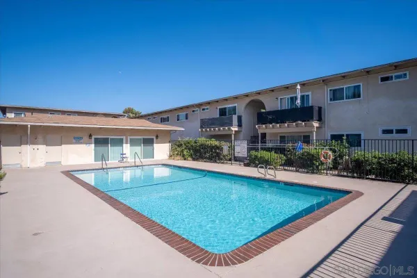 a view of a house with a backyard and a patio