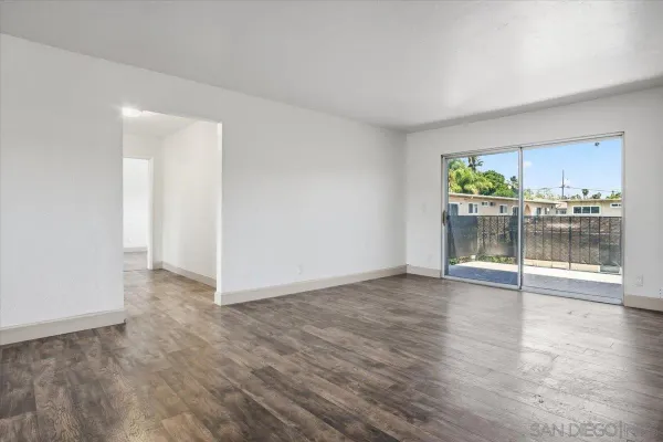 a view of a room with wooden floor