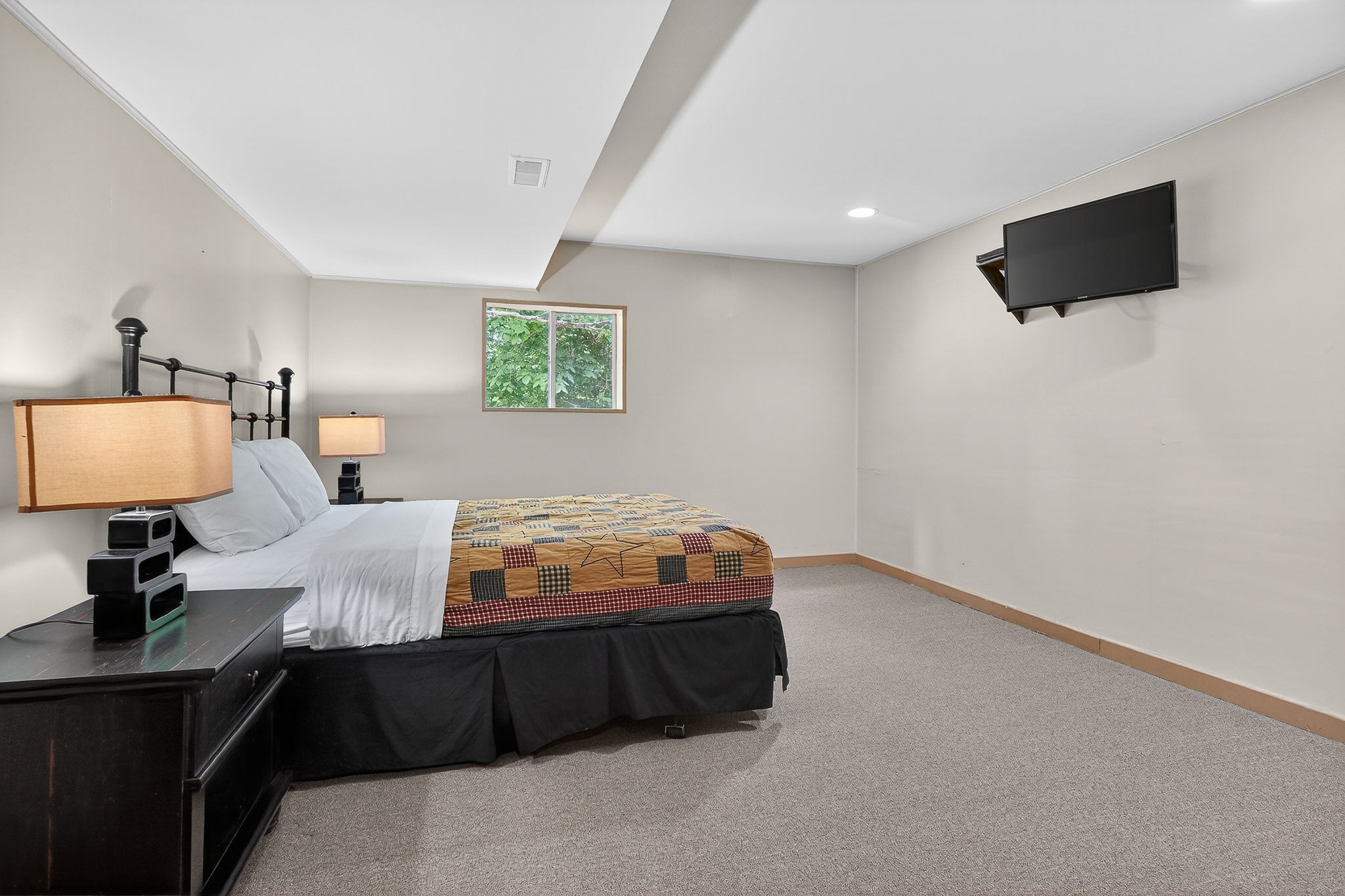 5642 Pates Ford Road Smithville, TN 37166 - Photo 19 of 32 a bedroom with a bed and a flat screen tv